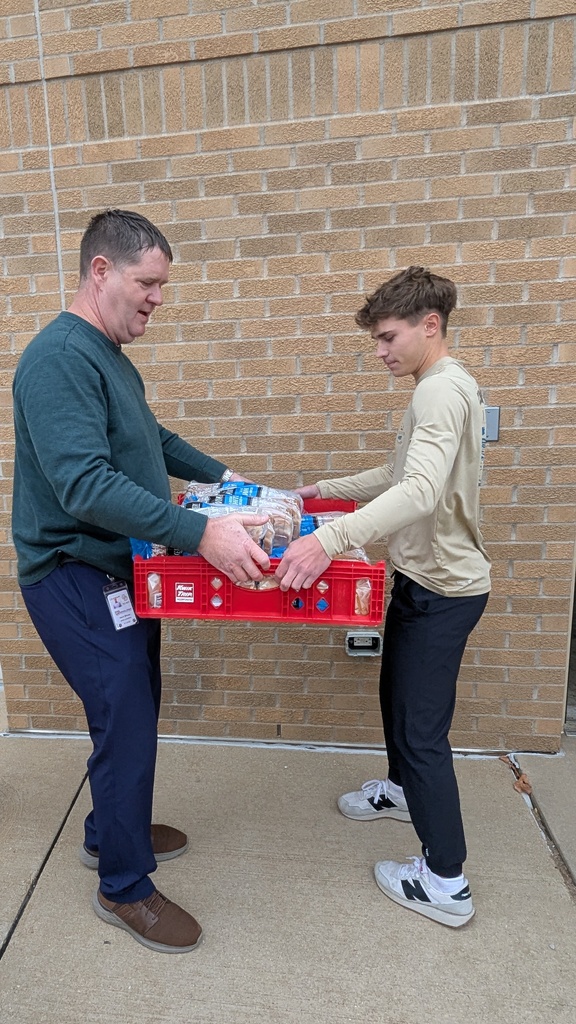NHS students putting together Thanksgiving baskets for families in need