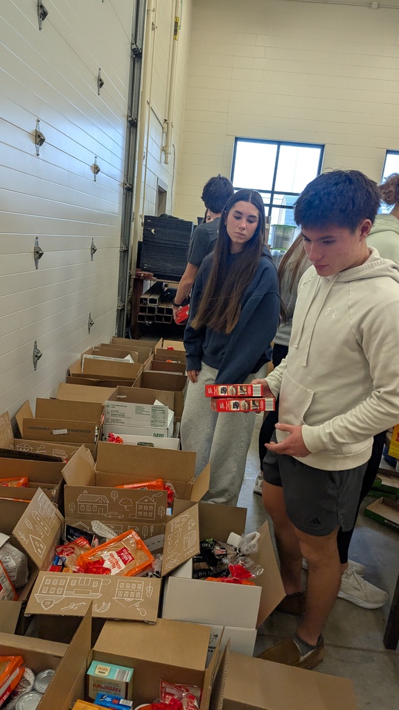 NHS students putting together Thanksgiving baskets for families in need