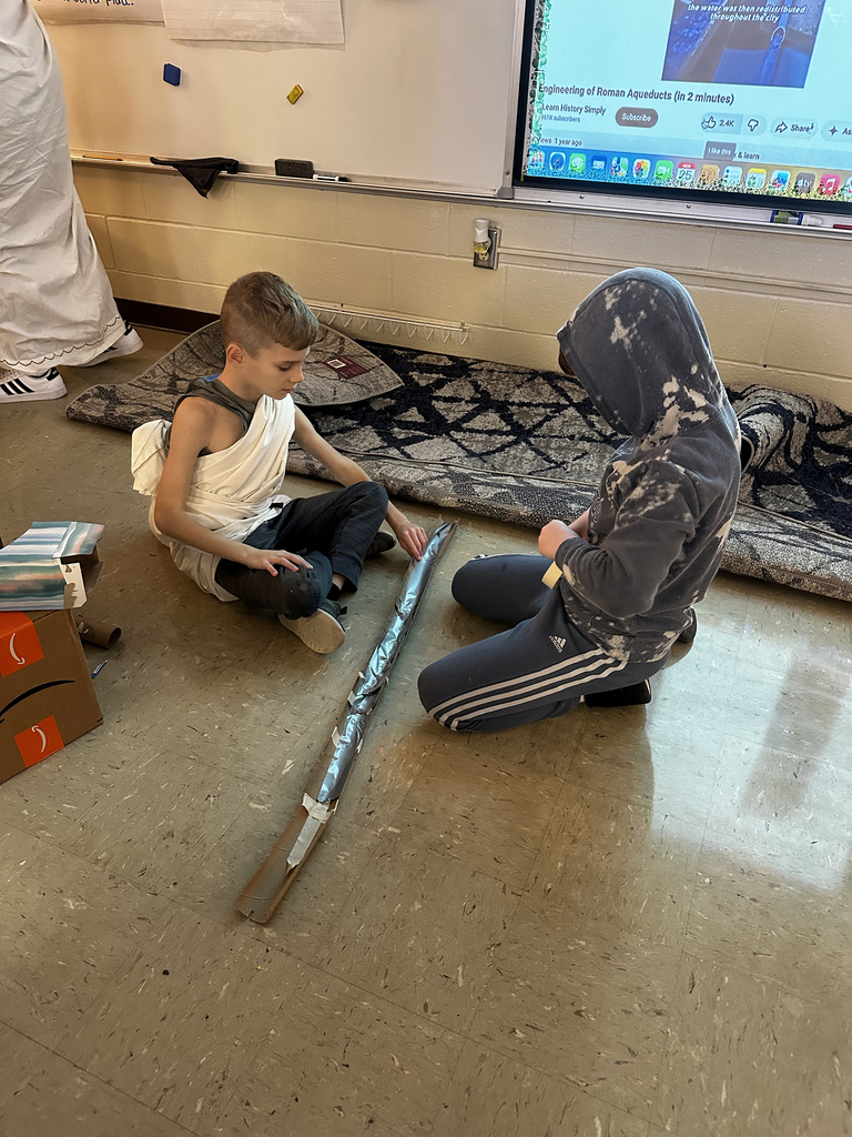 Third graders building and testing aquaducts