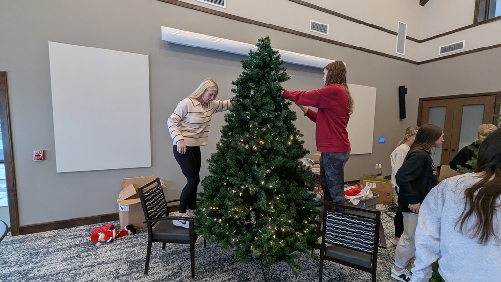 FFA and NHS students decorating Christmas trees at Fieldstone Senior Living