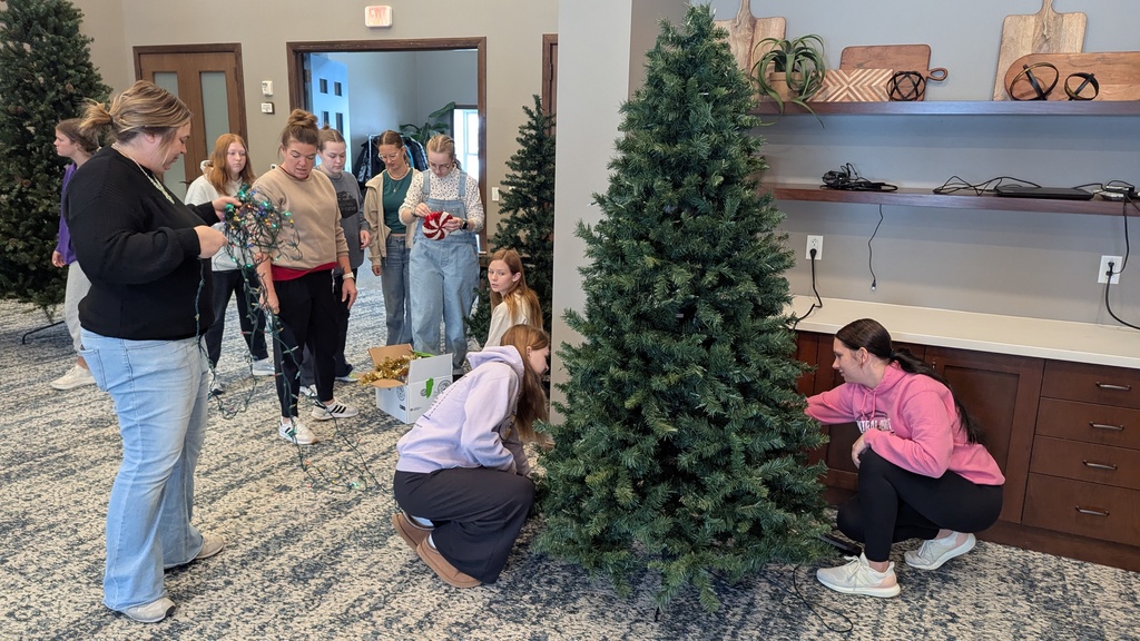 FFA and NHS students decorating Christmas trees at Fieldstone Senior Living