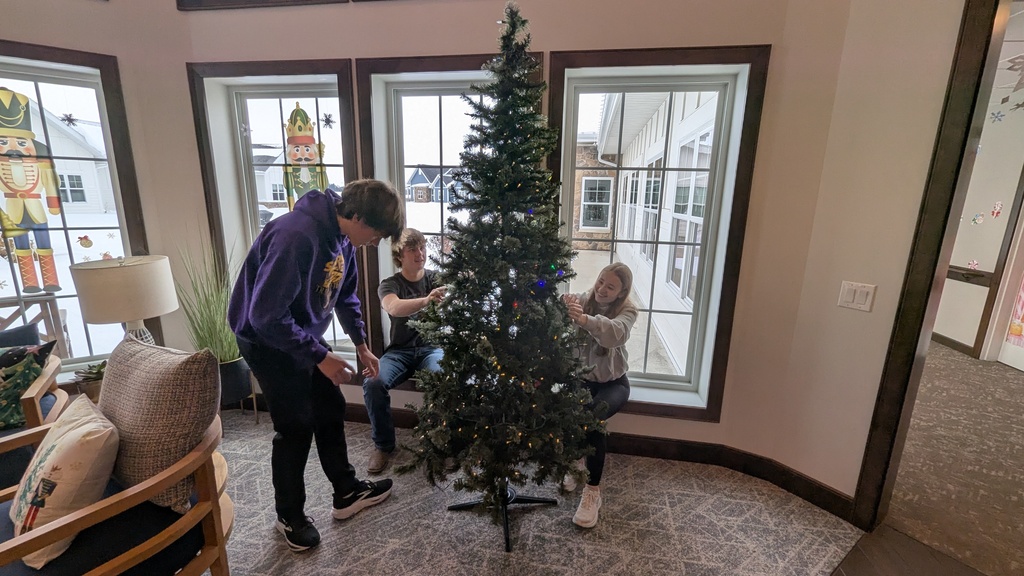 FFA and NHS students decorating Christmas trees at Fieldstone Senior Living