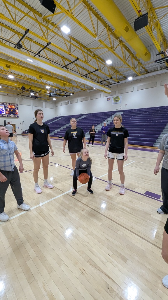 Saber girls basketball team and Unified Special Olympic athletes and partners practicing basketball