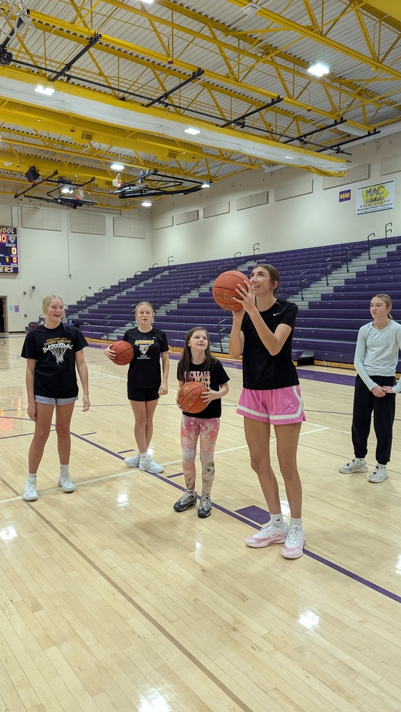 Saber girls basketball team and Unified Special Olympic athletes and partners practicing basketball