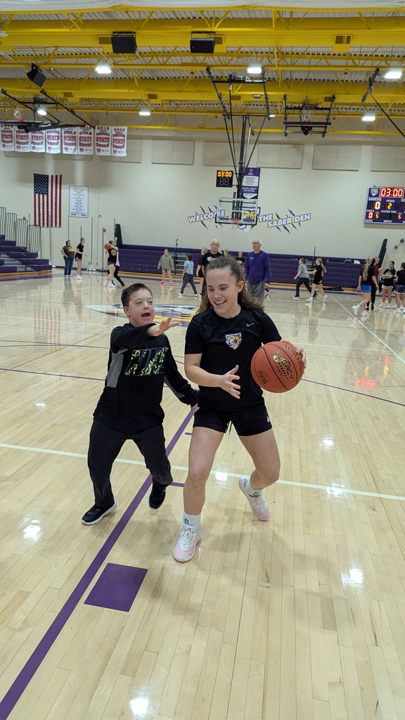 Saber girls basketball team and Unified Special Olympic athletes and partners practicing basketball