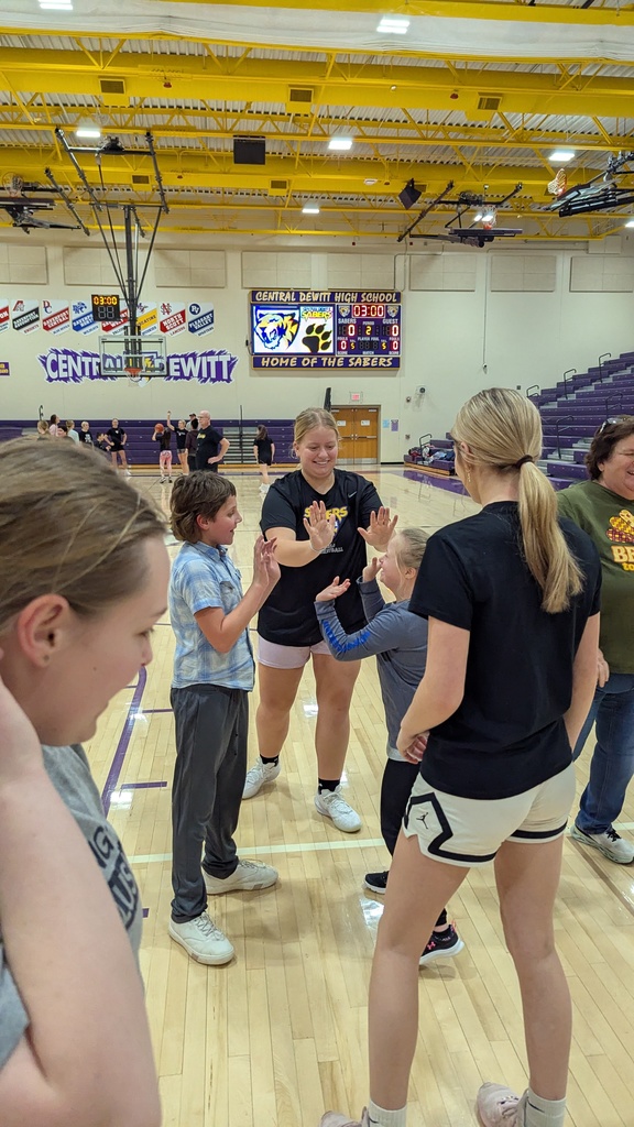 Saber girls basketball team and Unified Special Olympic athletes and partners practicing basketball