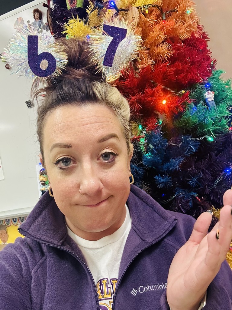 Art teacher Ms. Janaszak showing her 6-7 hair pom poms