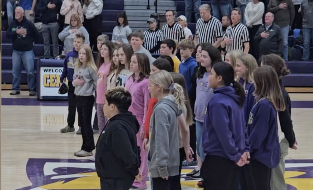 6th Grade Choir singing the National Anthem at the boys basketball game