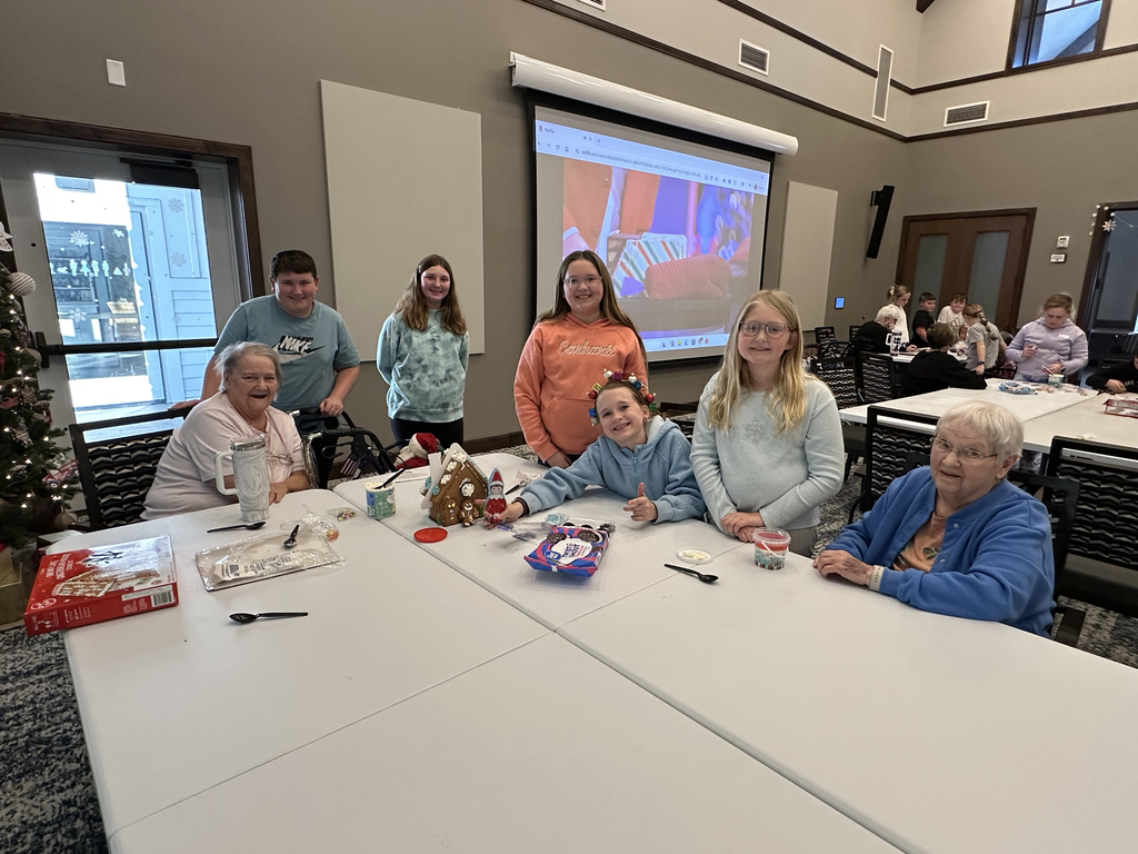 5th Grade Kindness Crew helping residents build gingerbread houses