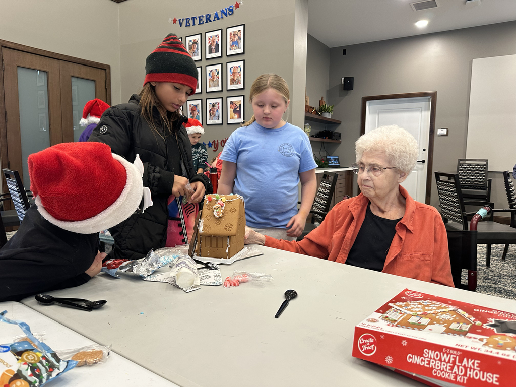 5th Grade Kindness Crew helping residents build gingerbread houses