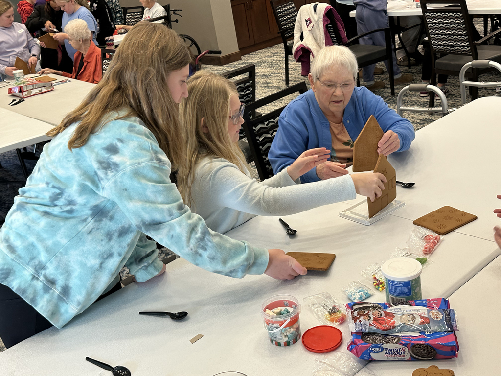 5th Grade Kindness Crew helping residents build gingerbread houses