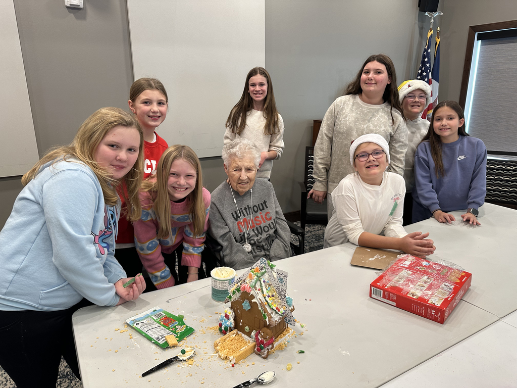 5th Grade Kindness Crew helping residents build gingerbread houses