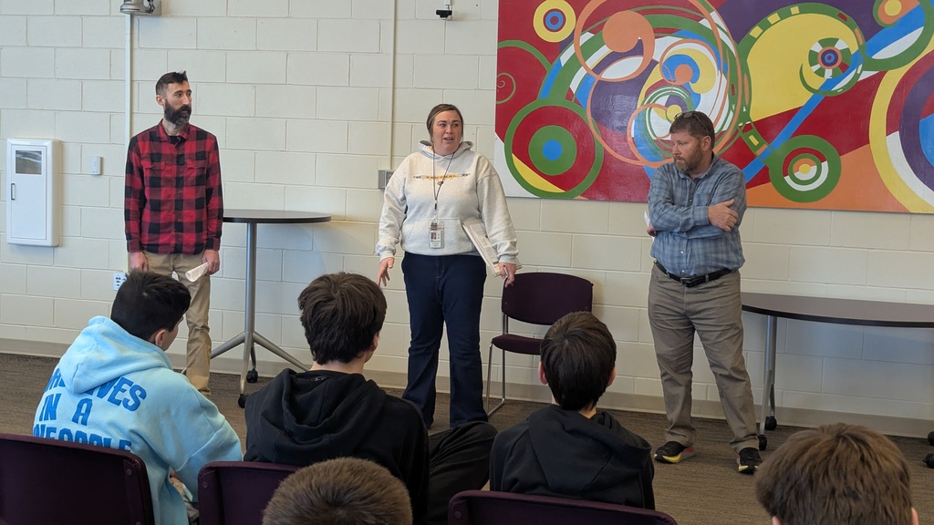 Mr. Prombo, Mrs. Grantz and Mr.  Marshall talking to 8th graders about courses they offer