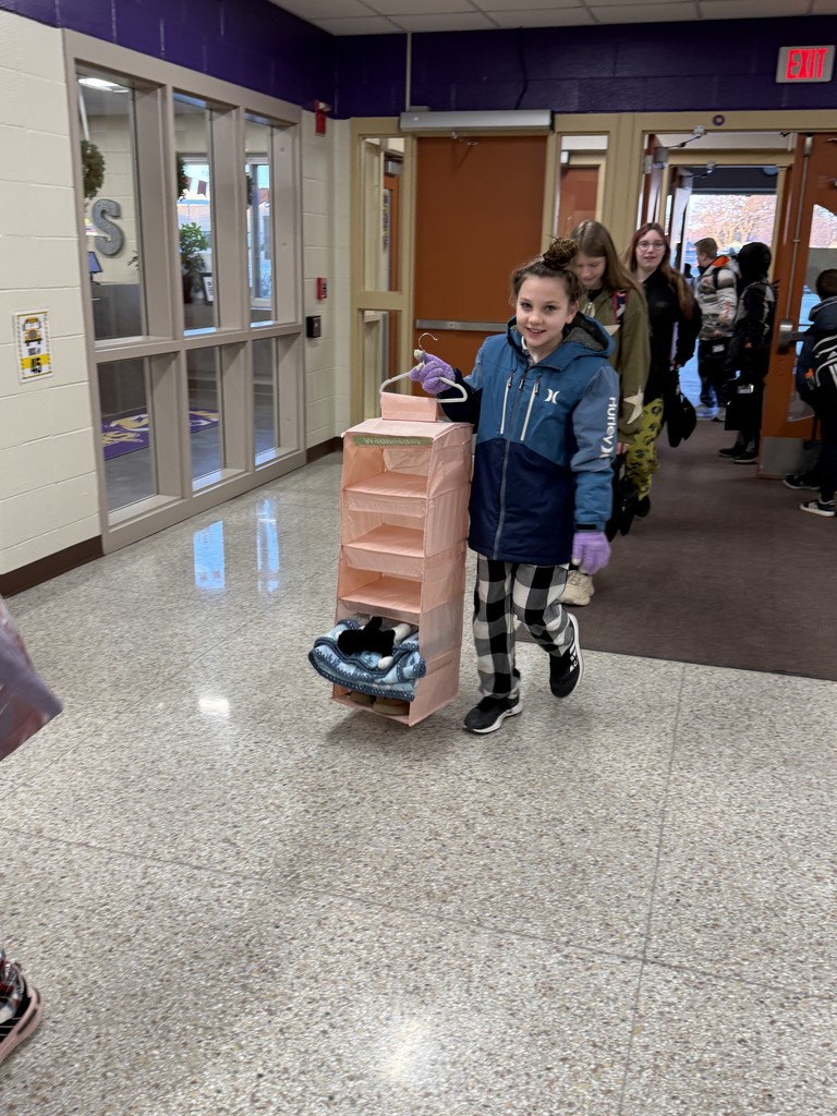 Student using a hanging organizer as a backpack