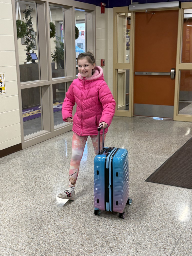 Student using a suitcase as a backpack