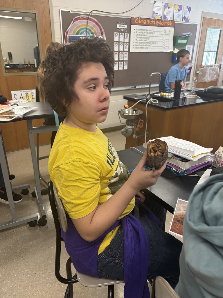 6th graders looking a cacao pod