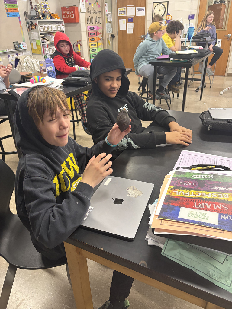 6th graders looking a cacao pod