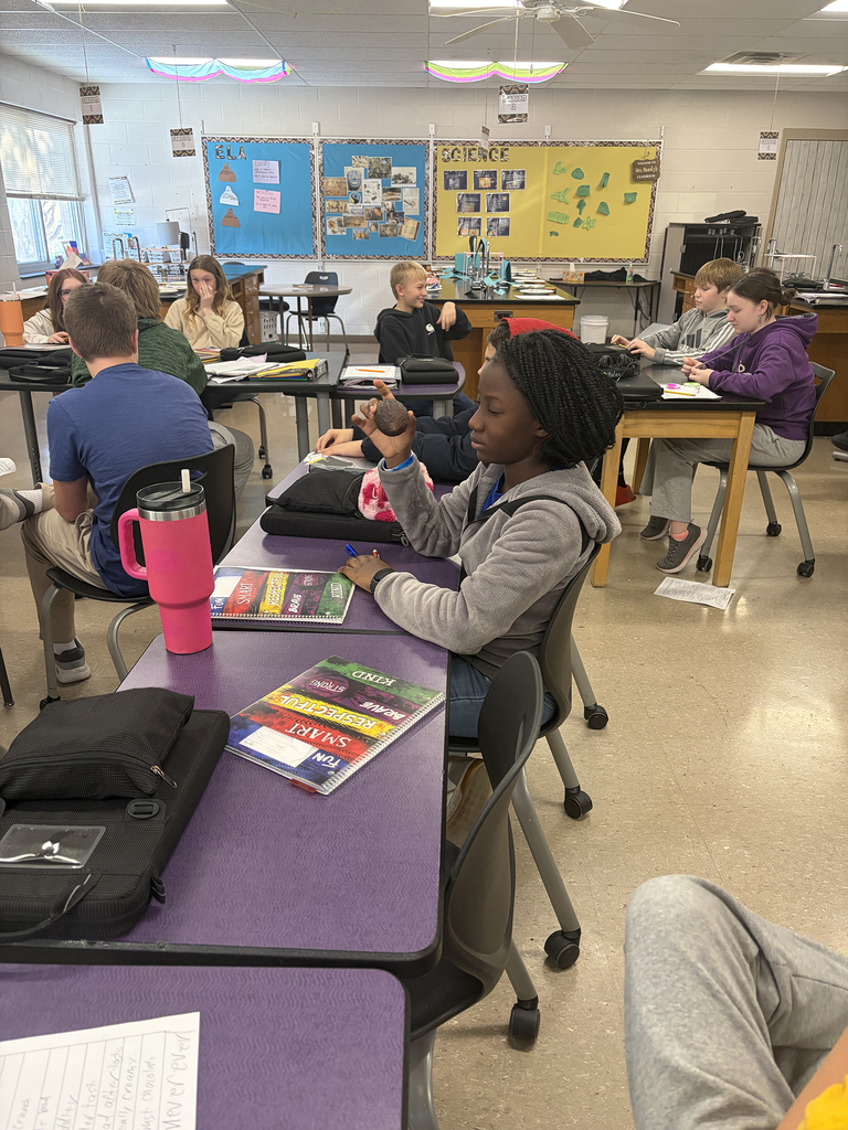 6th graders looking a cacao pod