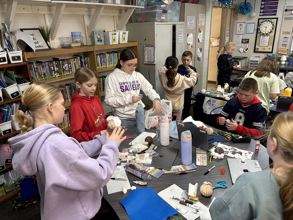 Students creating plastic bottle biography figures