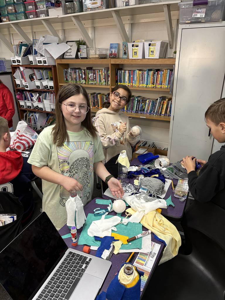 Students creating plastic bottle biography figures