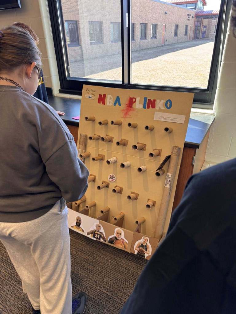 Students playing arcade games built by STEM 7 class