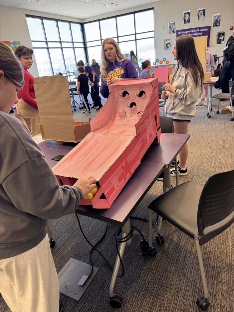 Students playing arcade games built by STEM 7 class