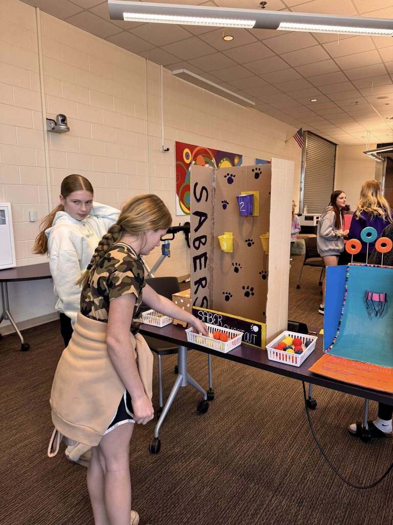 Students playing arcade games built by STEM 7 class