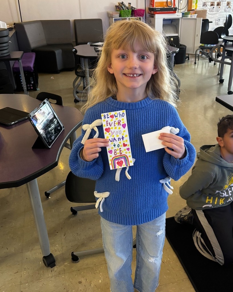 Student showing her bookmark that was chosen in the PTO Bookmark Design Contest
