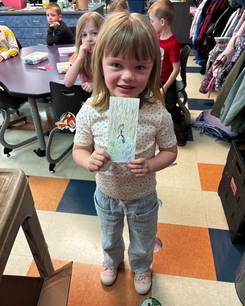 Student showing her bookmark that was chosen in the PTO Bookmark Design Contest