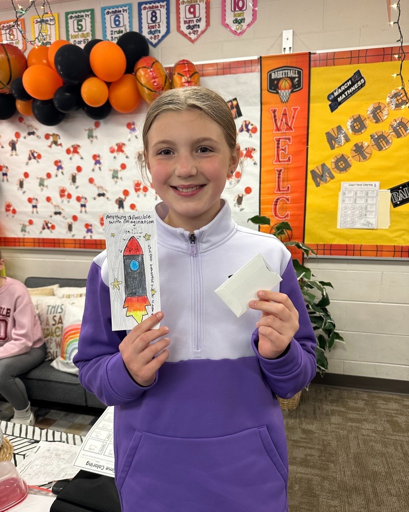 Student showing her bookmark that was chosen in the PTO Bookmark Design Contest