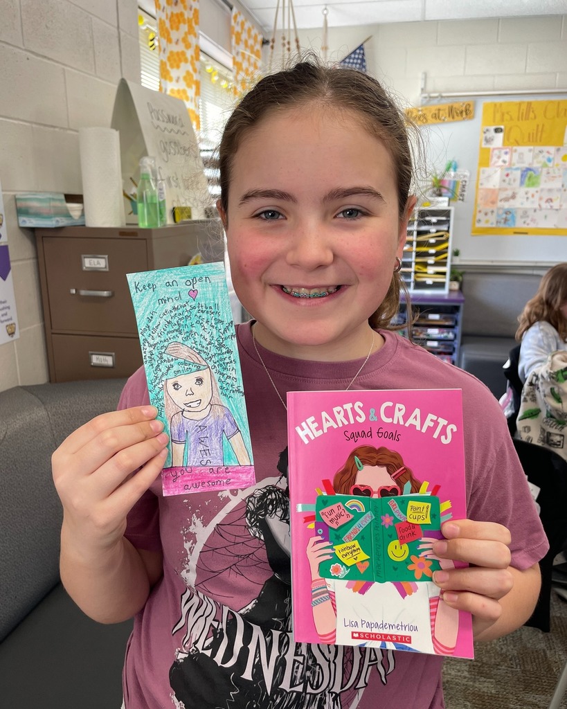 Student showing her bookmark that was chosen in the PTO Bookmark Design Contest