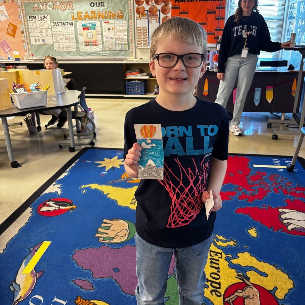 Student showing her bookmark that was chosen in the PTO Bookmark Design Contest