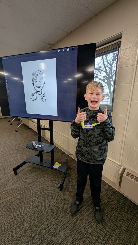 Lane Adams in front of the sketch LeUyen Pham did of him