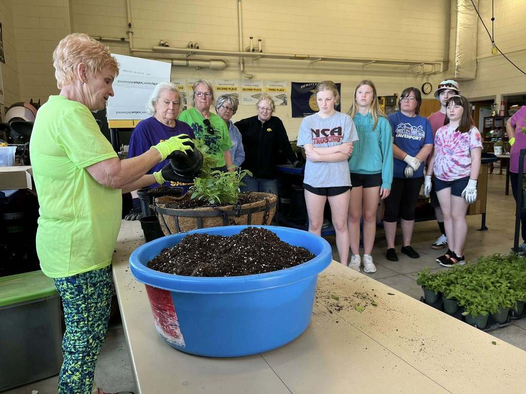 Horticulture students making hanging baskets for downtown