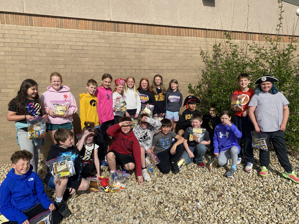 Students showing off the "loot" they found during their treasure hunt