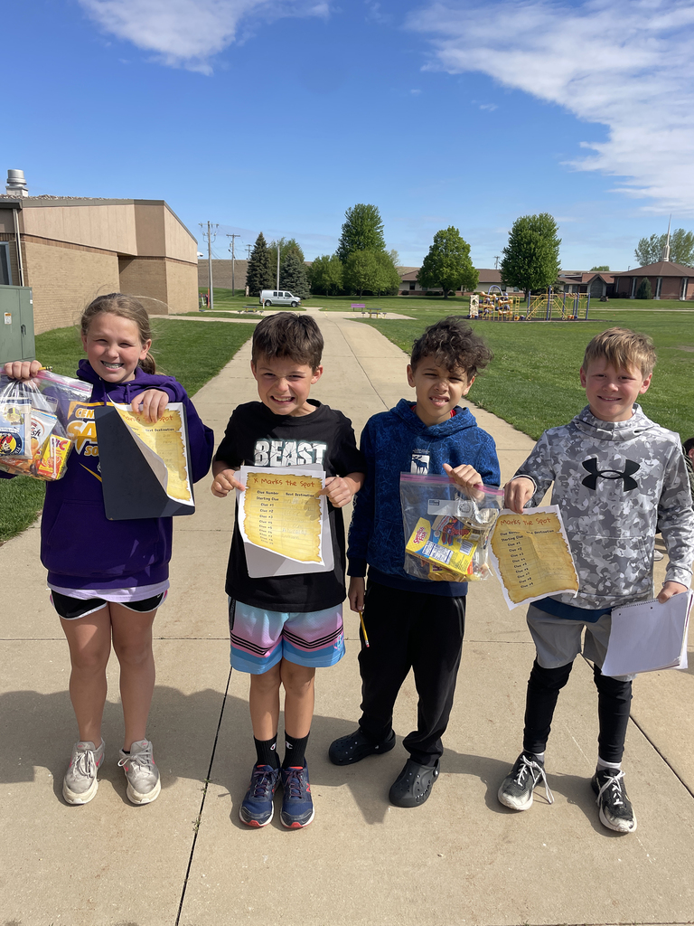Students showing off the "loot" they found during their treasure hunt