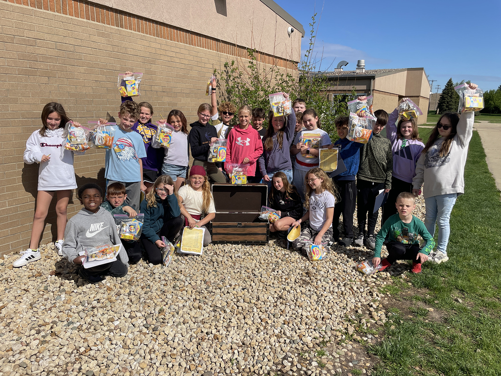 Students showing off the "loot" they found during their treasure hunt