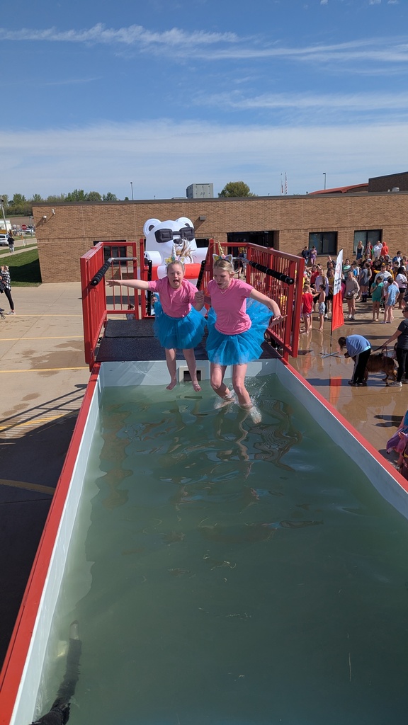 Students dressed as unicorn ballerinas jumping into the tank