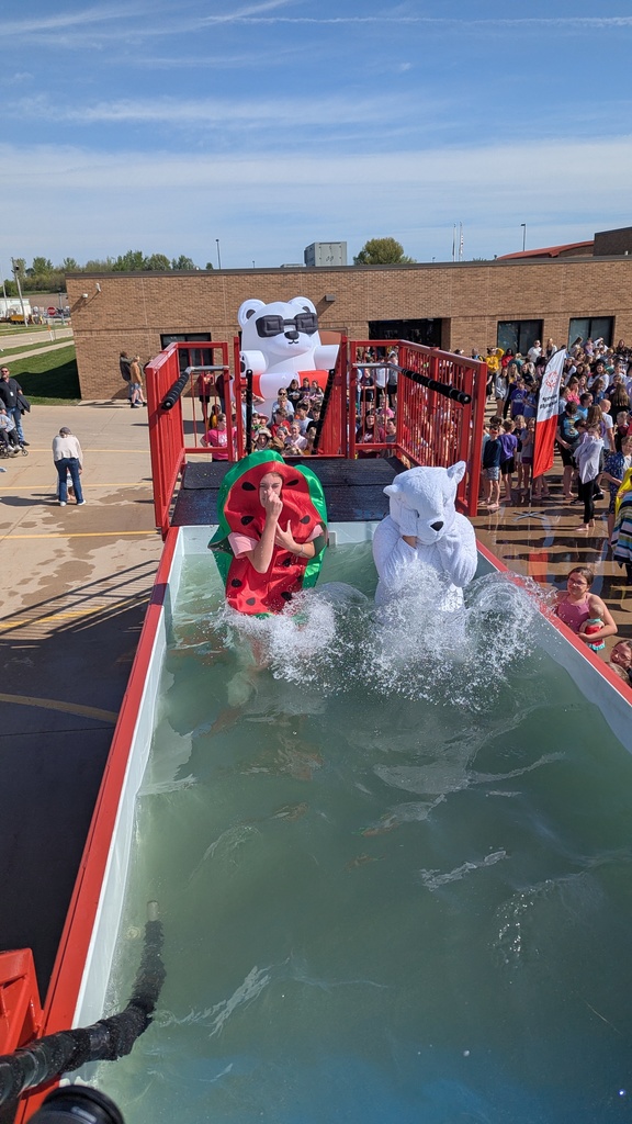 Students dressed as watermelon and a polar bear jumping into the tank