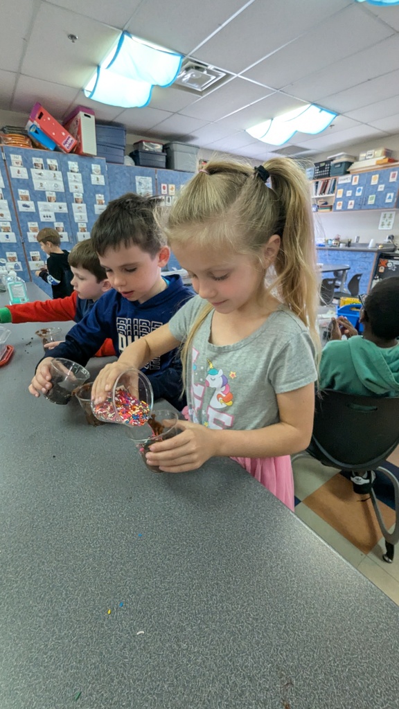 Kindergarteners assembling their "dirt cups"