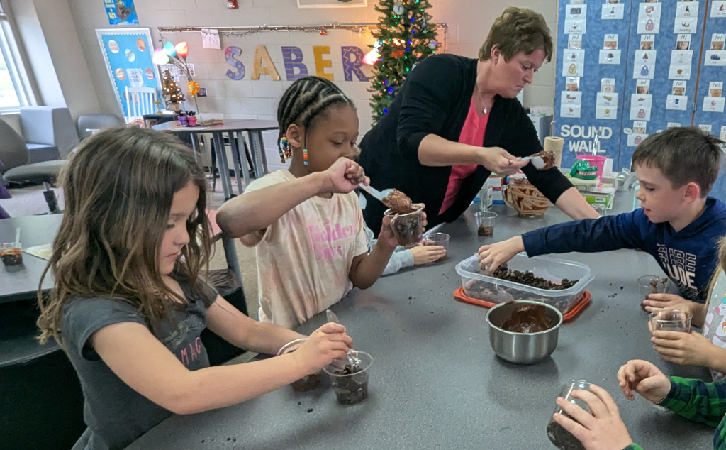 Kindergarteners assembling their "dirt cups"