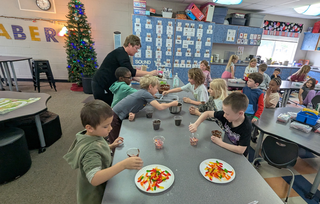 Kindergarteners assembling their "dirt cups"