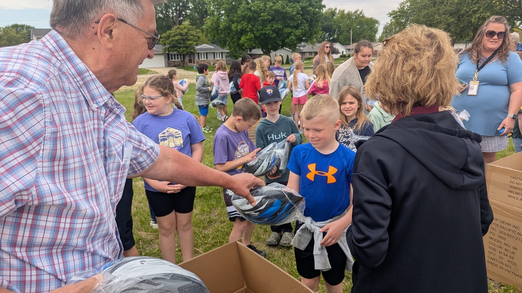Second graders receiving their bike helmets from LincolnWay Community Foundation and Crossroads Health Foundation volunteers