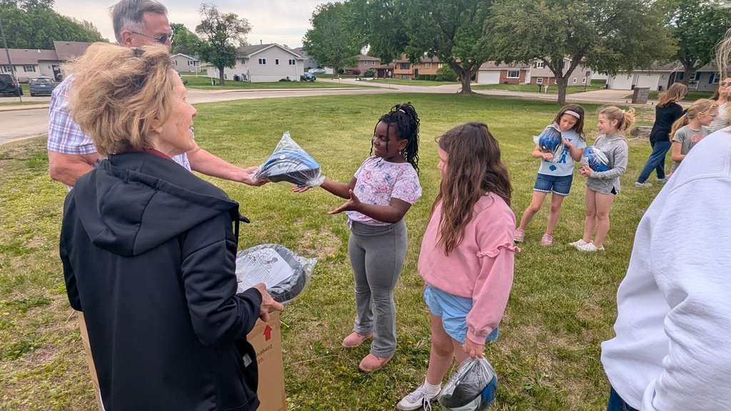 Second graders receiving their bike helmets from LincolnWay Community Foundation and Crossroads Health Foundation volunteers