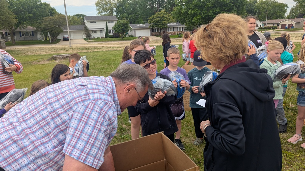 Second graders receiving their bike helmets from LincolnWay Community Foundation and Crossroads Health Foundation volunteers