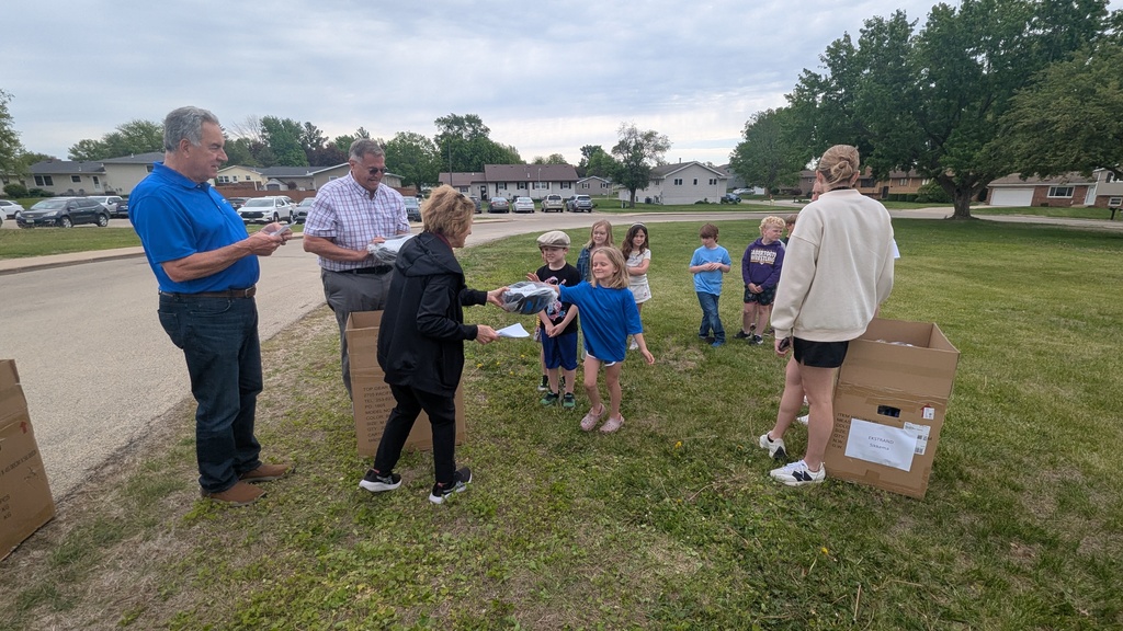 Second graders receiving their bike helmets from LincolnWay Community Foundation and Crossroads Health Foundation volunteers