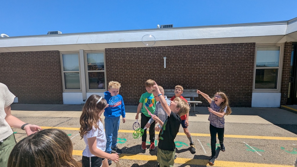 Second graders blowing bubbles using a special bubble recipe that uses corn syrup