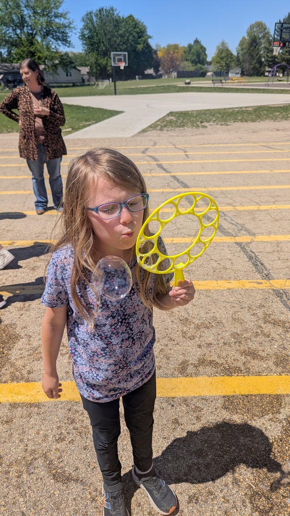 Second graders blowing bubbles using a special bubble recipe that uses corn syrup