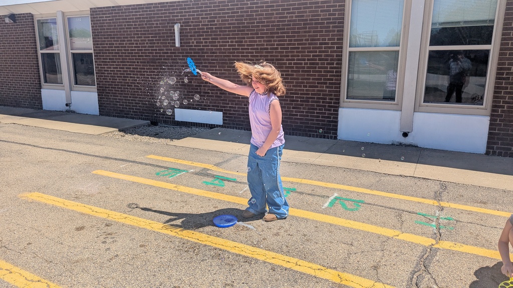 Second graders blowing bubbles using a special bubble recipe that uses corn syrup
