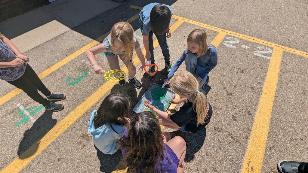 Second graders blowing bubbles using a special bubble recipe that uses corn syrup